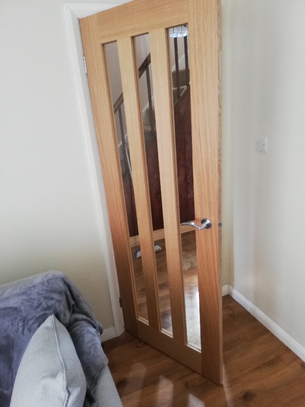 Wooden interior door with glass windows.