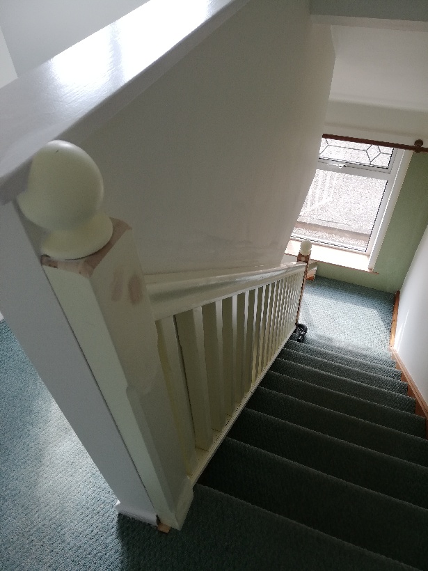 White bainsters with square spindles on stairs.