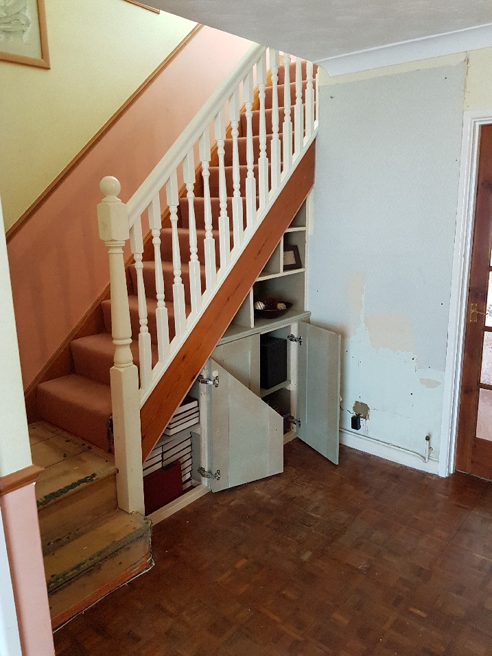 Storage cupboards beneath stairs.
