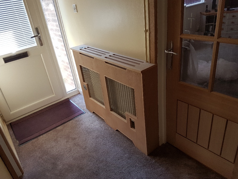 Pine wooden radiator cover that can act as shelving.